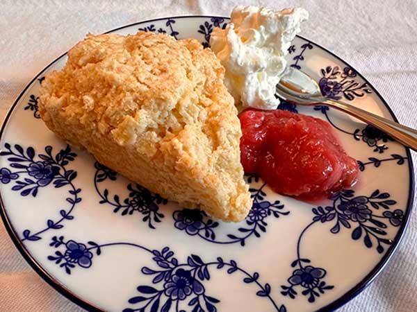 Easy cream scone with rhubarb jam and whipped cream.